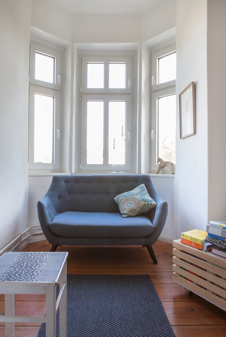 Designer sofa in window bay of period apartment