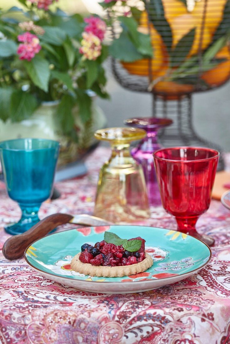 Berry tart on summery table outside