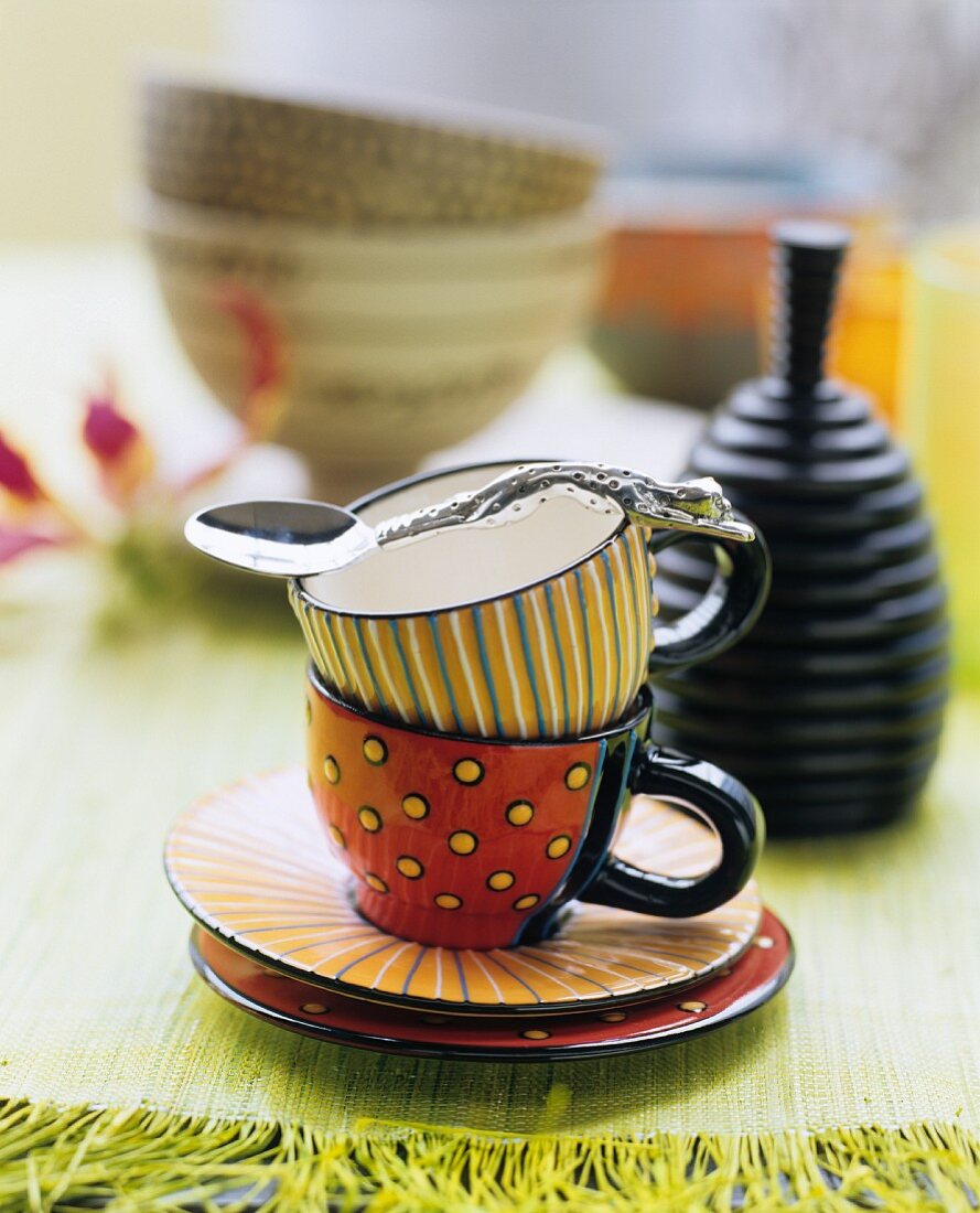 Teacups painted with graphic patterns