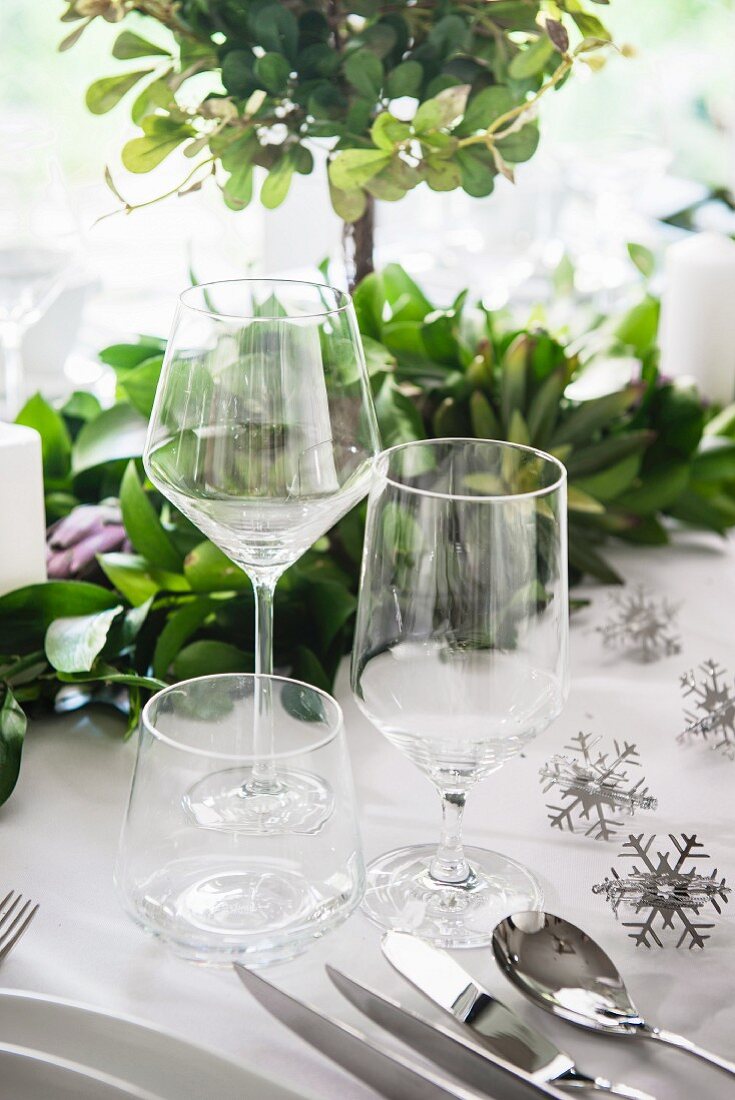 Empty wine and water glasses on table set for Christmas dinner