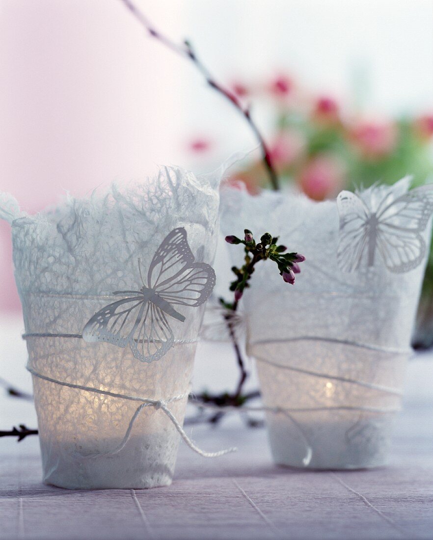 Rice paper tealight holders decorated with butterflies and sprig of flower buds