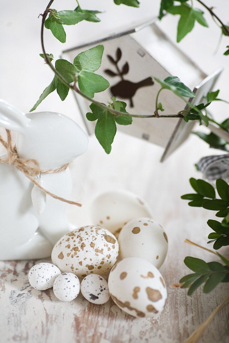 Speckled Easter eggs, china rabbit and tendrils of ivy