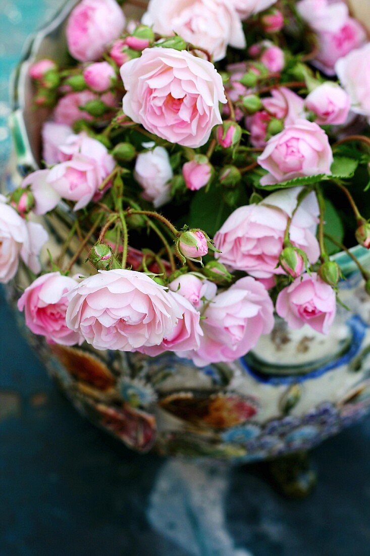 Ceramic vase of freshly-cut pink roses