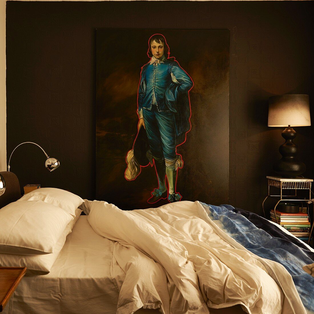 Double bed in front of portrait of man in Baroque clothing outlined in red leaning against wall painted dark brown