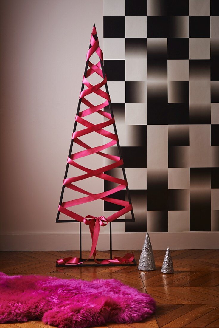 Modern Christmas tree made from metal frame with pink silk ribbon