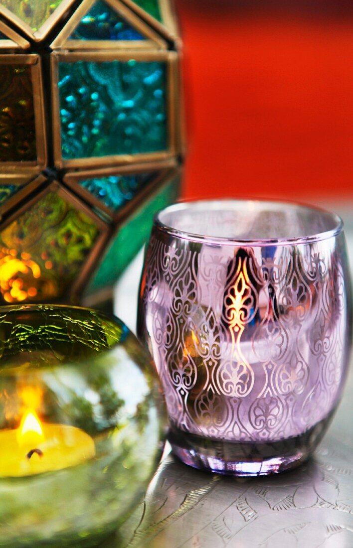 Candles in colourful Oriental tealight holders with ornate patterns