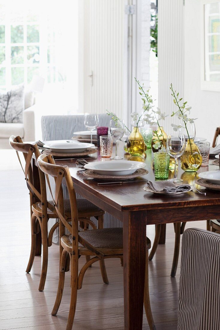 Wooden, Scandinavian-style chairs around set dining table