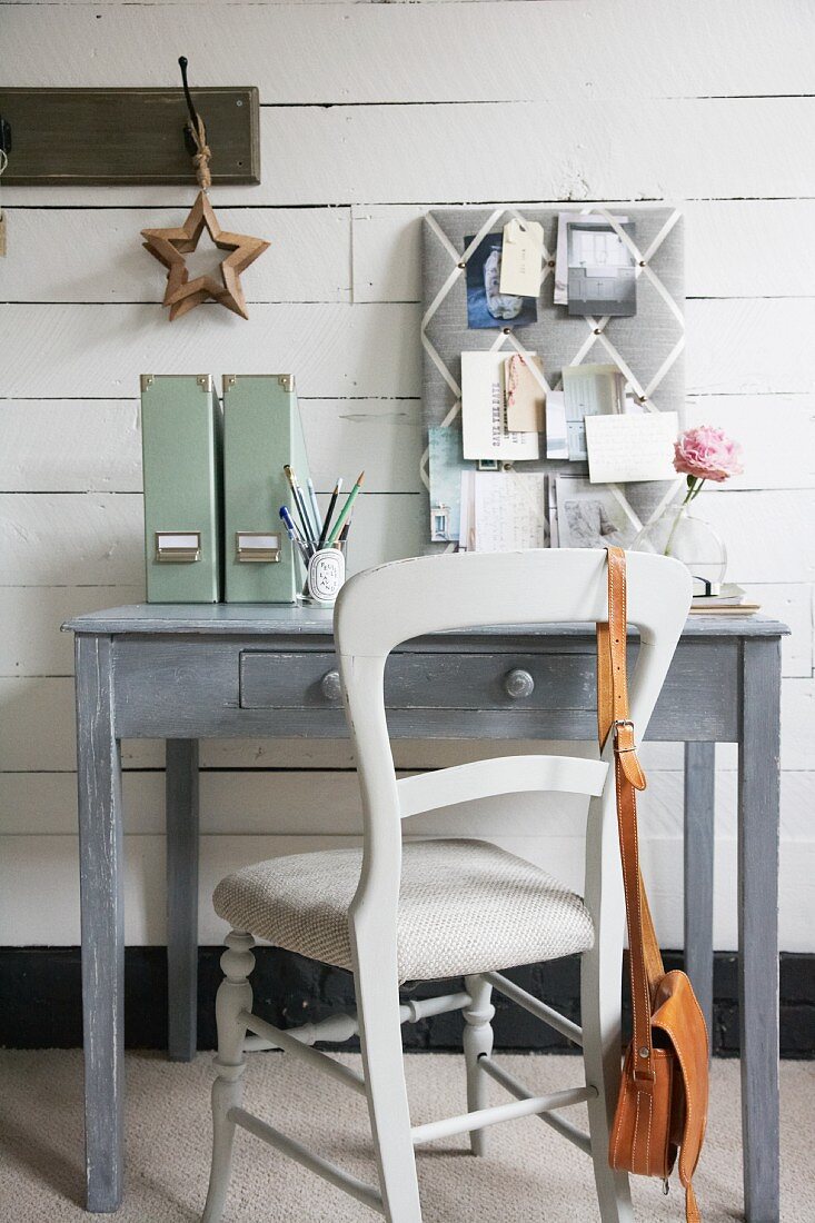 Shabby chic study area in grey with fabric pin board on painted wooden wall