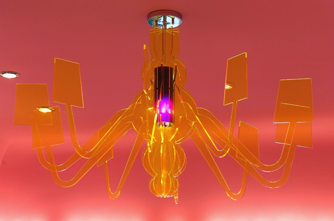 Yellow glass chandelier on red ceiling