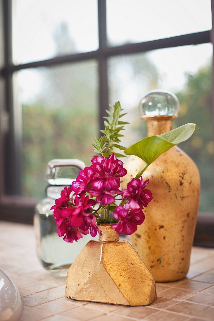 Close-up of a jar and vase against blurred window