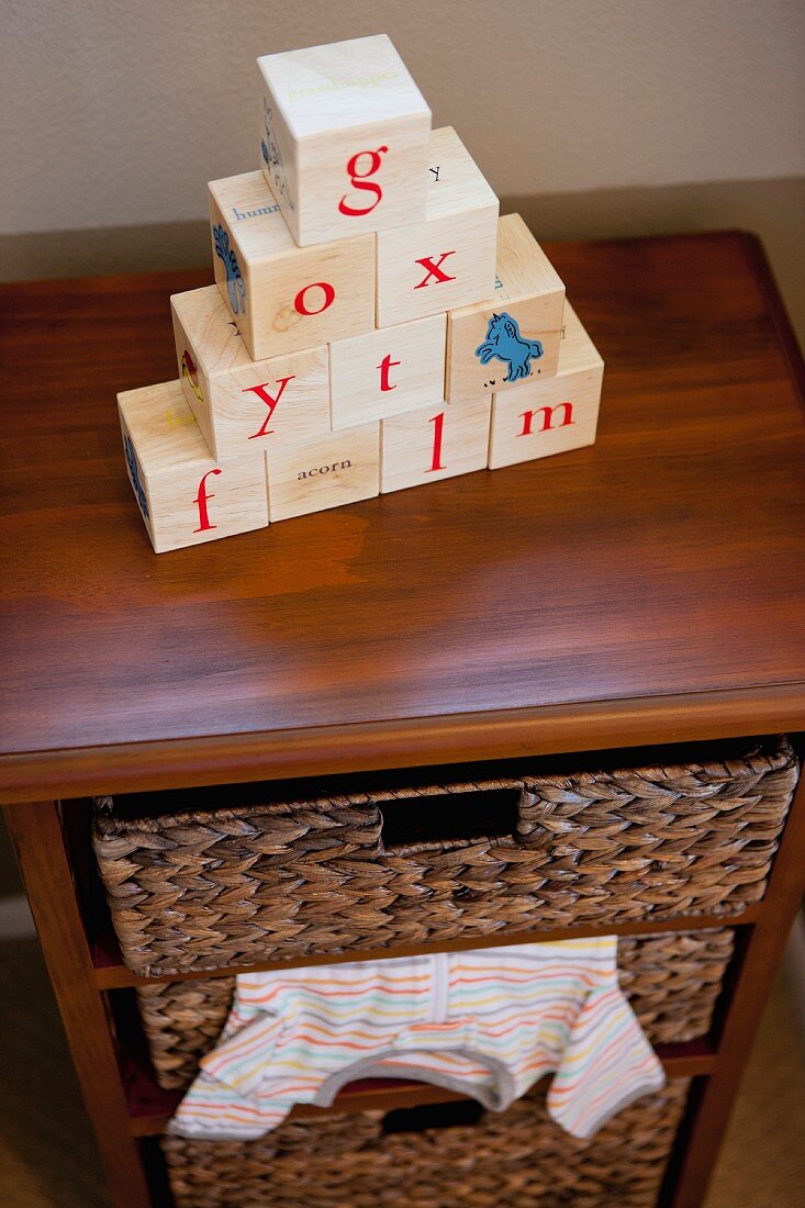 Alphabets blocks on chest of drawers in child's room