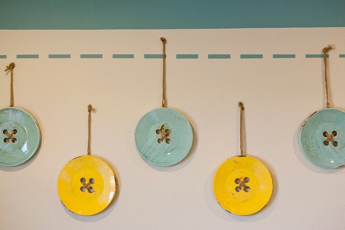 Blue and yellow buttons hanging in child s room