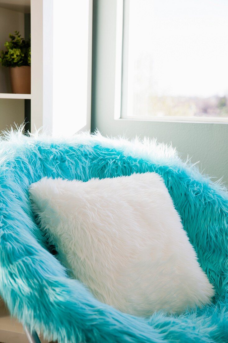 Close-up of a blue fur shell chair