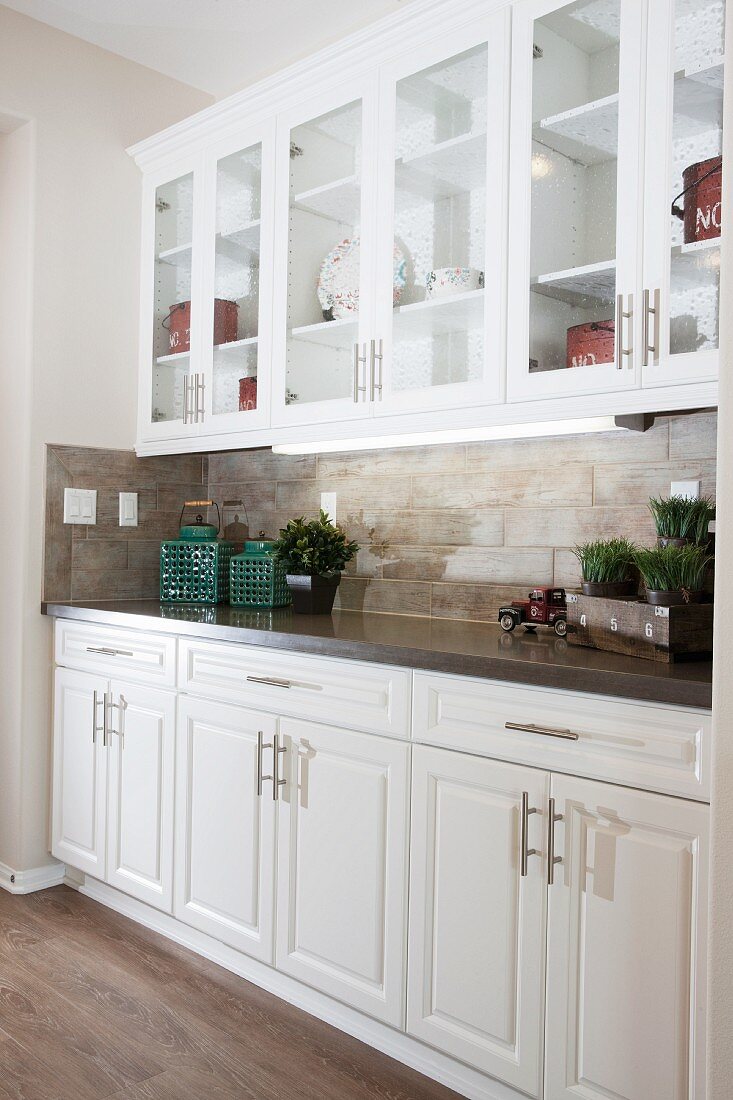 White cabinets and glass cabinets in kitchen