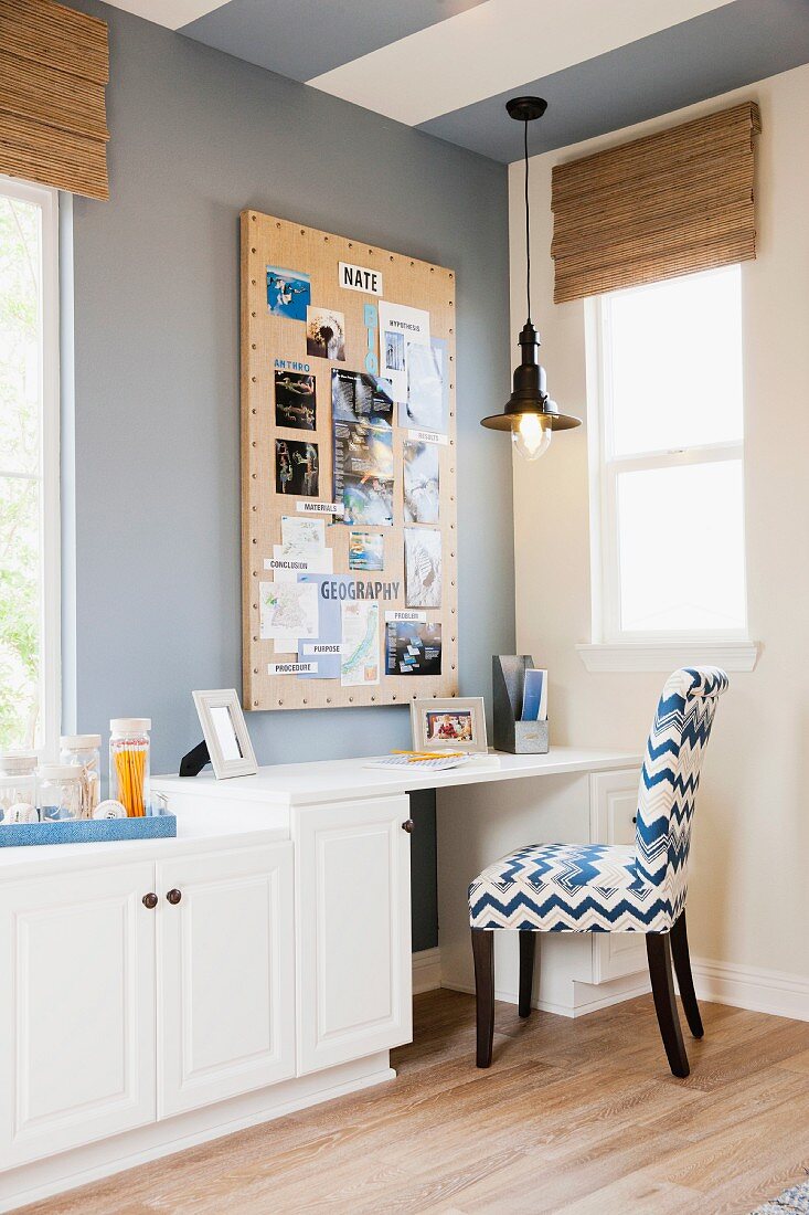 Chair at desk with white cabinets