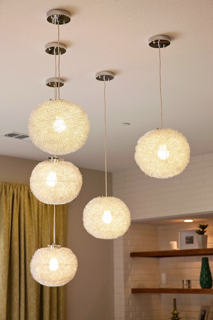 Close-up of lit round pendant lamps