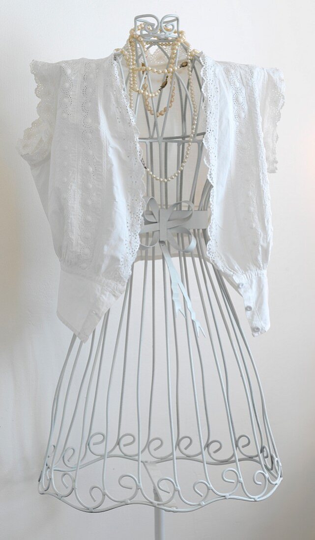 Nostalgic lace blouse on white, vintage-style, wire tailors' dummy