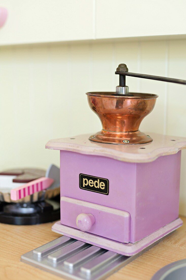 Purple coffee mill in toy kitchen