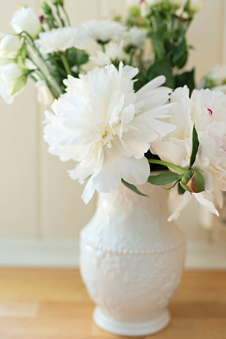 White peonies in porcelain vase