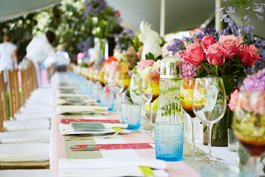 Long dining table in garden set for birthday party