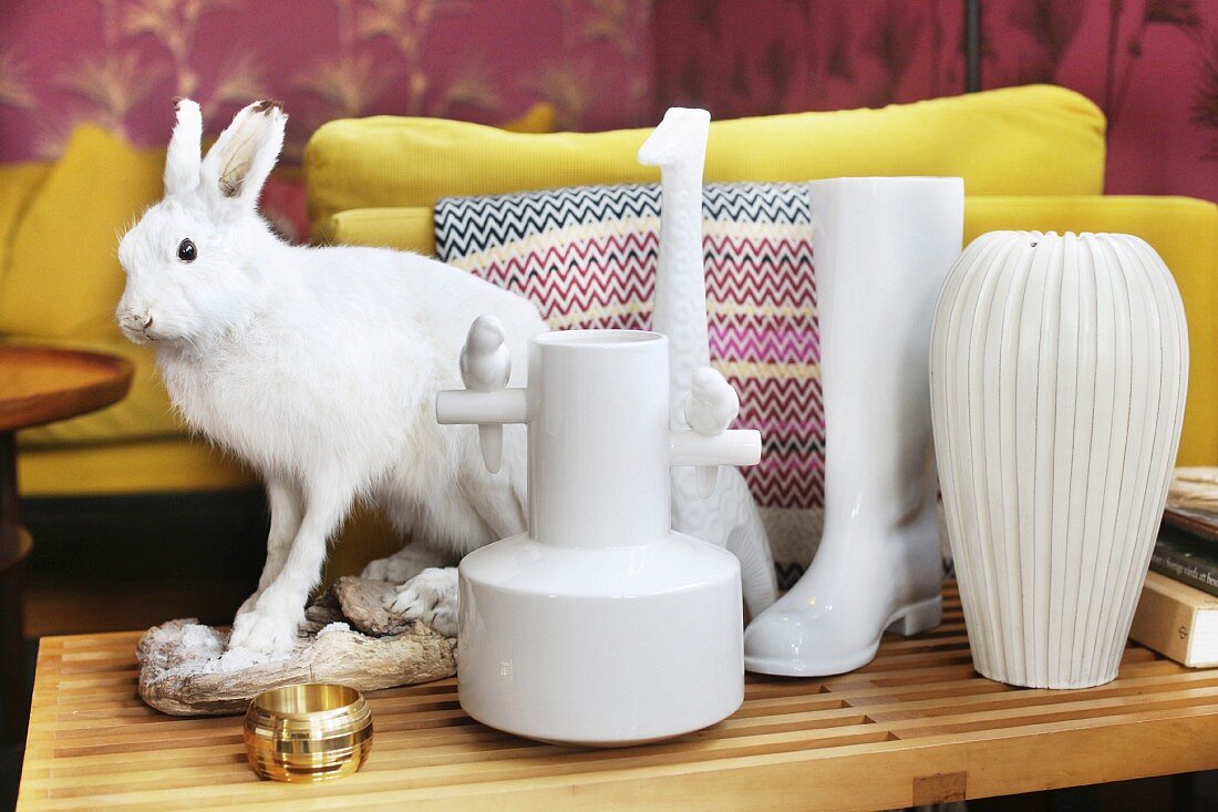 Various white vases and hare ornament on side table