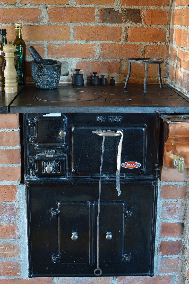Black, vintage stove integrated in brick counter