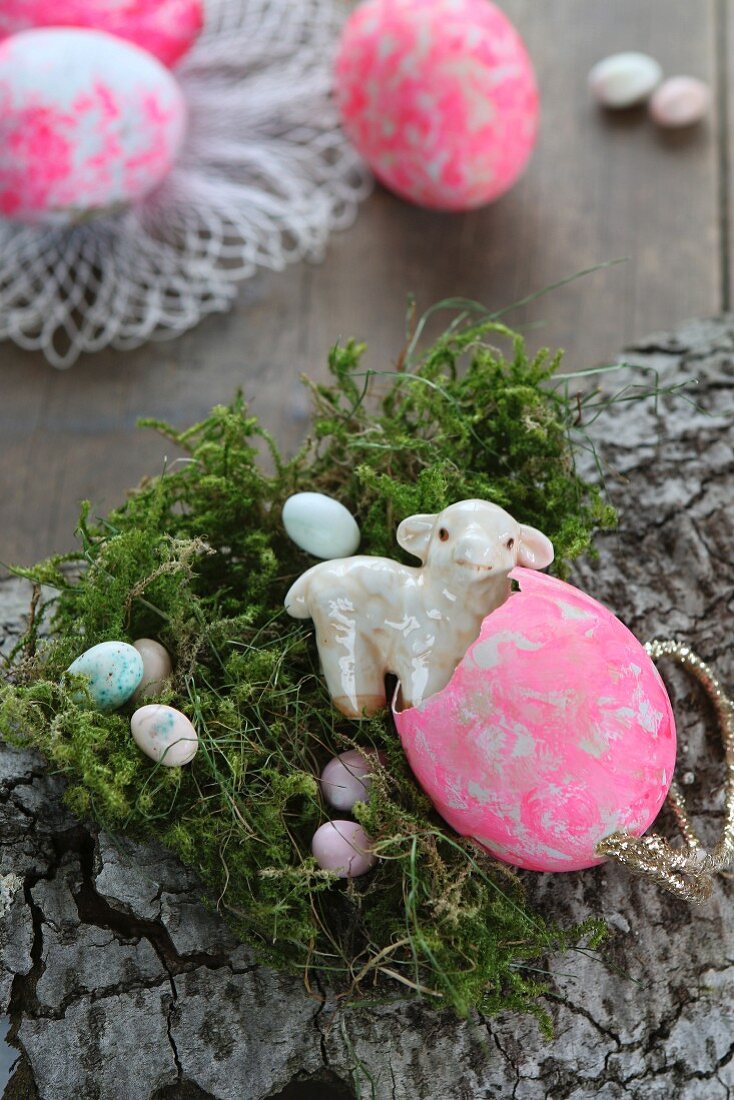 Easter arrangement of bark, moss, sugar eggs and china lamb