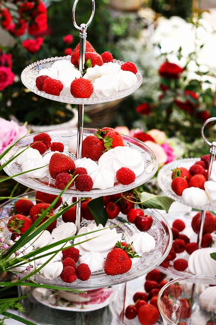 Meringues, raspberries, strawberries and cherries on cake stand