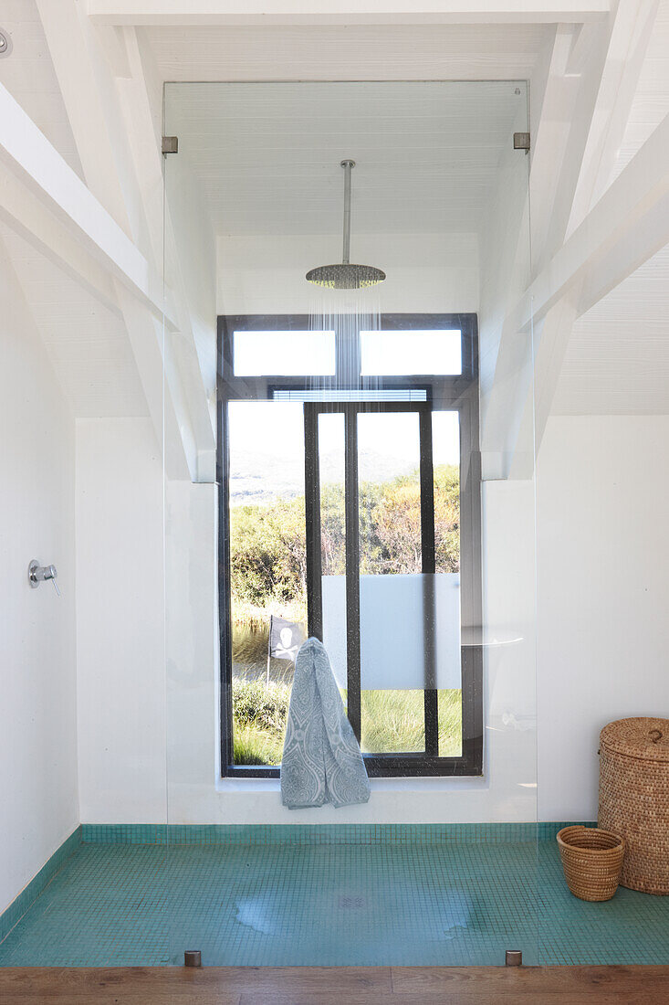 Floor-level shower area with window and glass screen