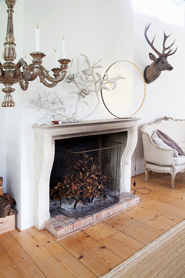 Open fireplace with circular decoration and papier-mâché flower