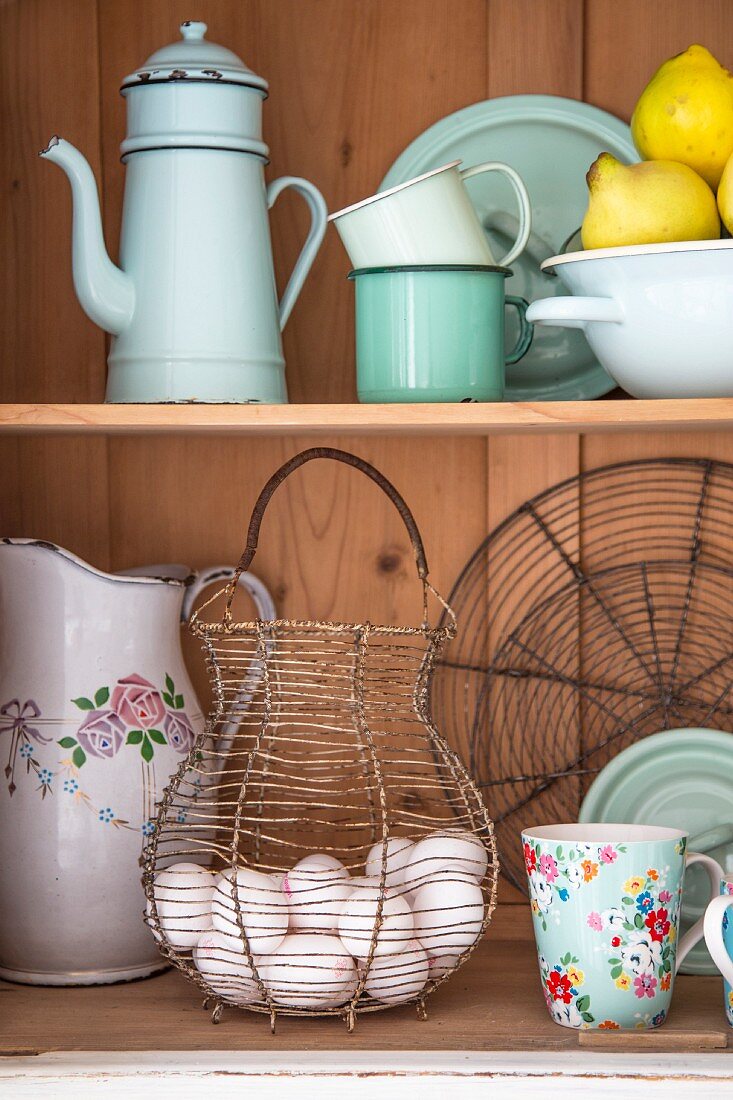 Enamel crocker, wire egg basket & other vintage kitchen equipment in dresser