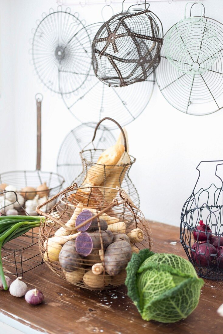 Various wire baskets used to store vegetables in kitchen