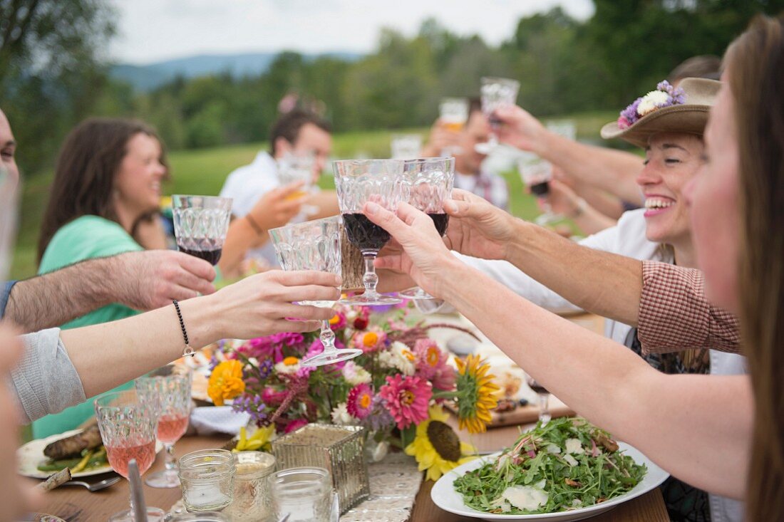 Family and friends raising a toast at outdoor meal