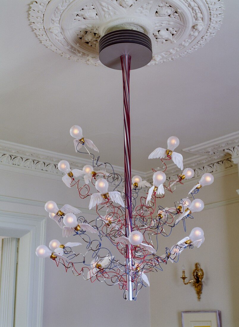 Modern Birds Birds Birds designer pendant lamp featuring stylised flying light bulbs suspended from stucco ceiling