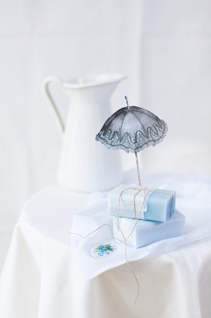 Forget-me-not soap and cut out paper parasol on cloth with forget-me-not motif
