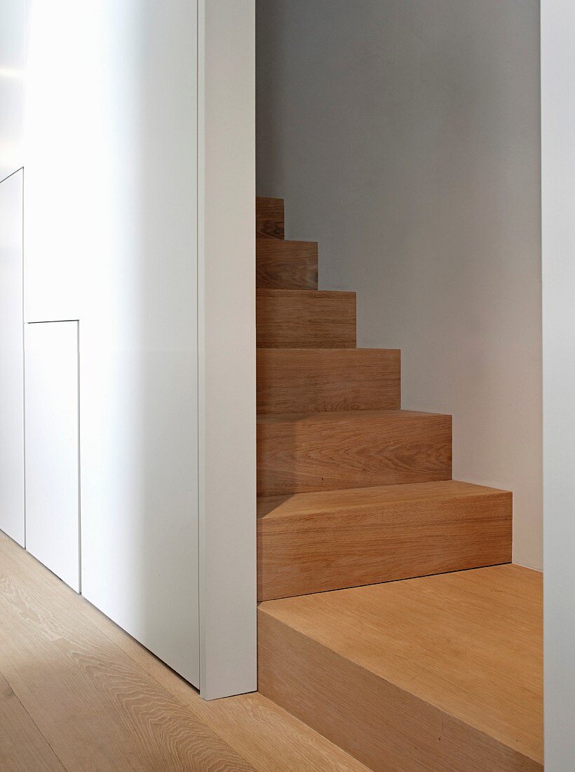 Private Apartment, London, United Kingdom. Architect: Hill Mitchell Berry, 2014. View from hallway into narrow staircase with wooden staircase