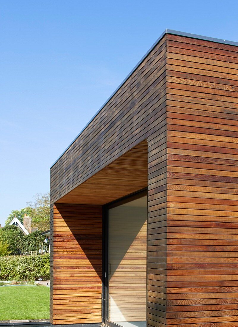 Teilweise sichtbares, zeitgenössisches Wohnhaus mit horizontaler Holzlverschalung