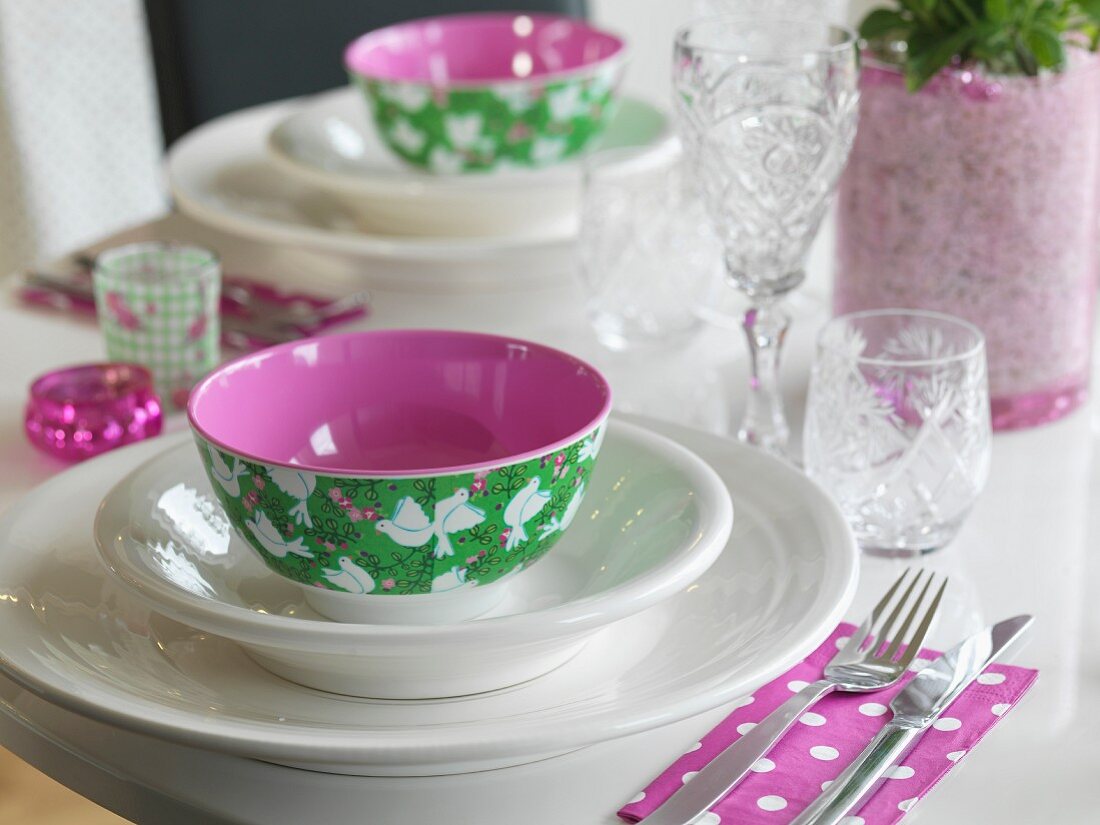 White place setting with colourful bowl and romantic pattern