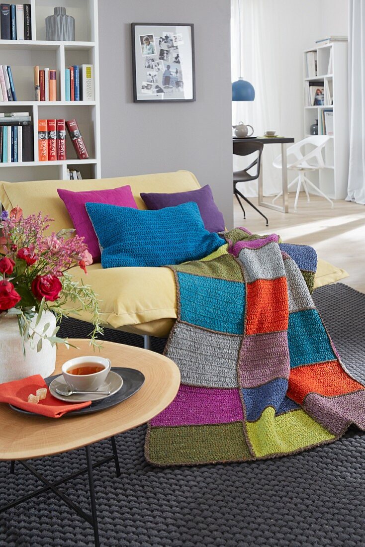 Crocheted cushions and a throw on a yellow armchair