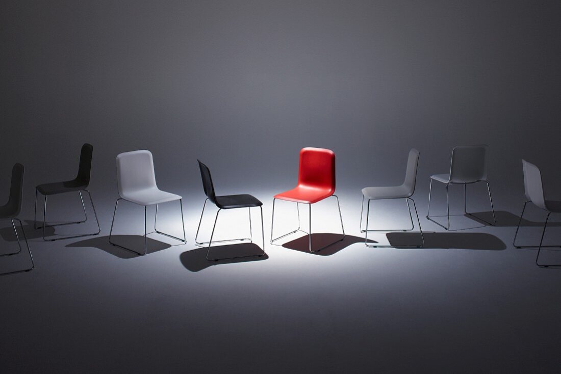 Modern chairs with white, black and red plastic seats