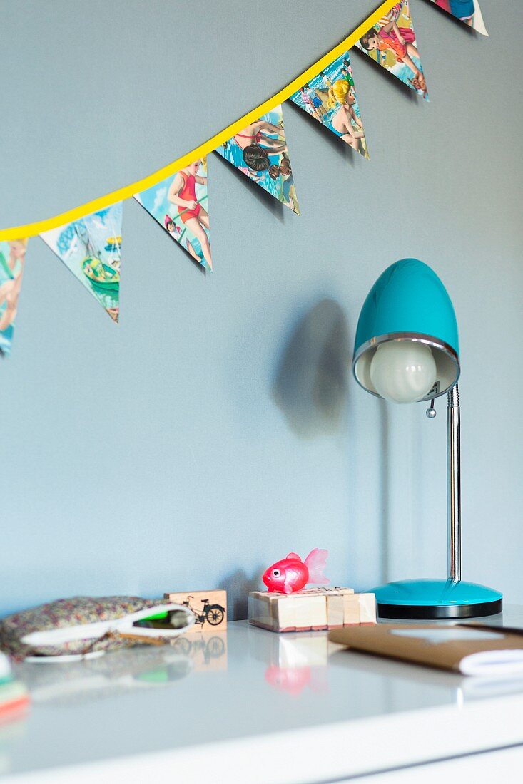 Hand-made, colourful bunting above desk in child's bedroom