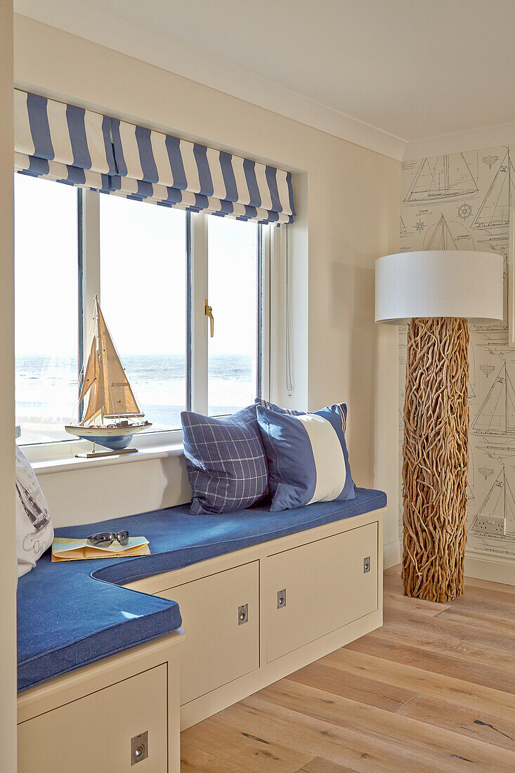 Window seat with maritime decoration and storage compartments