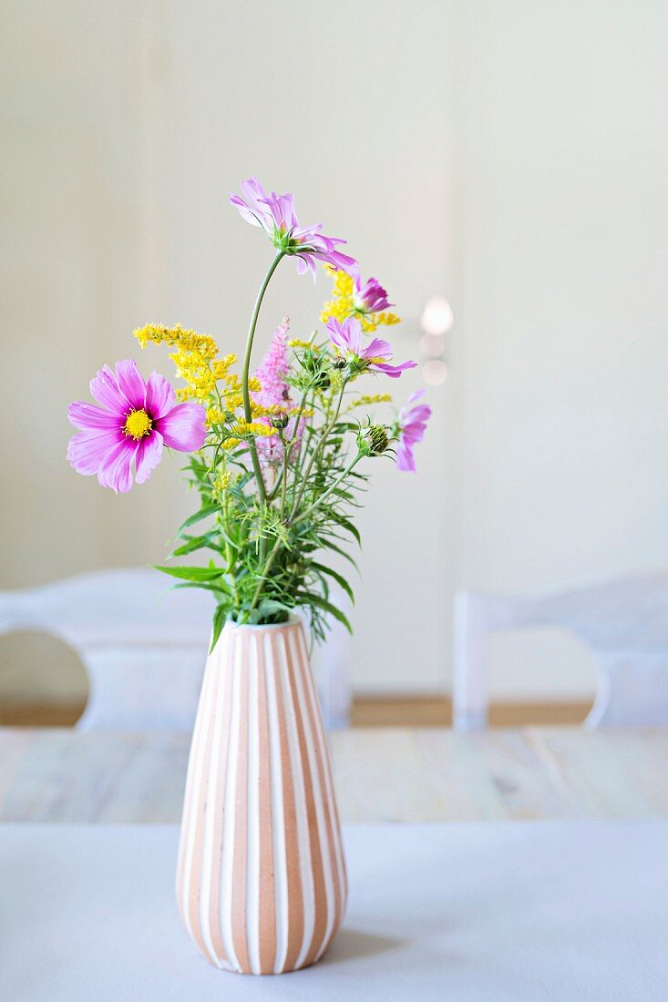 Garden flowers in vase with pleated structure