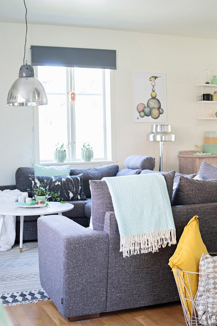 Retro pendant lamps with metal lampshades above sofa combination in shades of grey