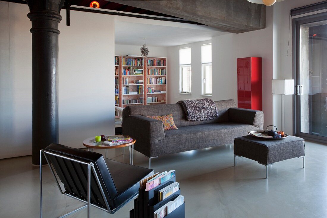 Lounge area in restored loft with old metal pillar