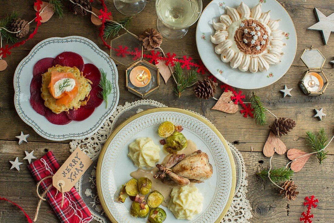 Christmas dinner, potato pancake with smoked salmon and beetroot, quail with Brussels sprouts and parsnip puree, Mont Blanc pavlova with chestnut puree
