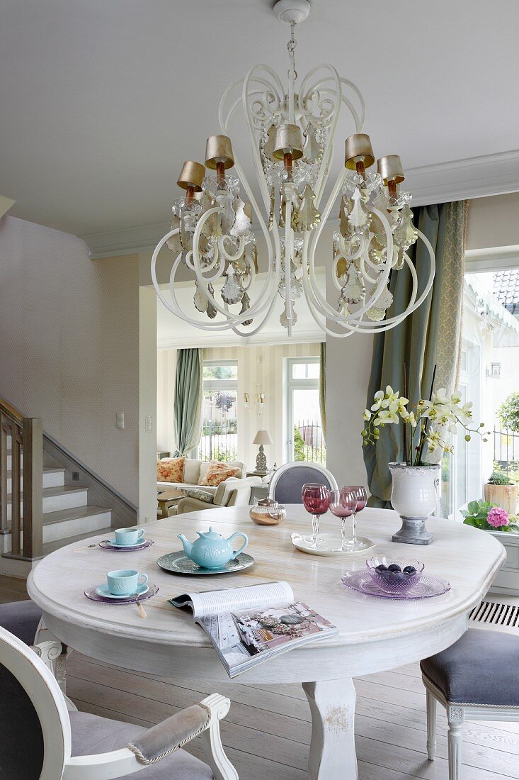 Dining area with opulent chandelier above dining table