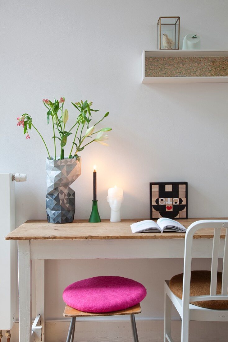 Stool with deep pink cushion and chair in front of rustic desk