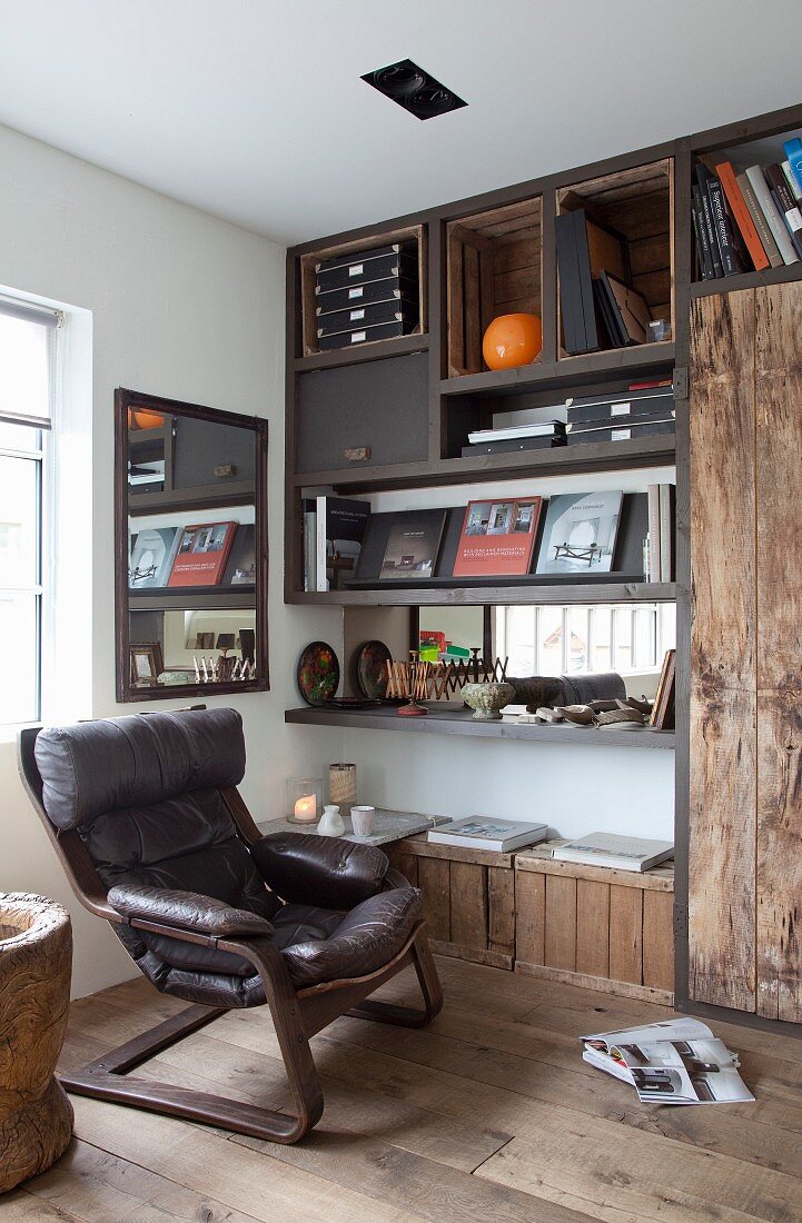 Vintage leather armchair in front of DIY shelving with rustic wooden elements