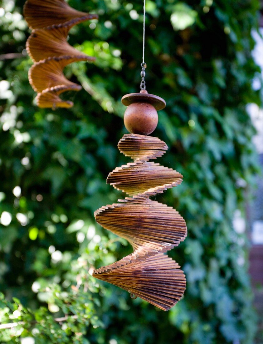 Wooden spiral mobile hanging in garden